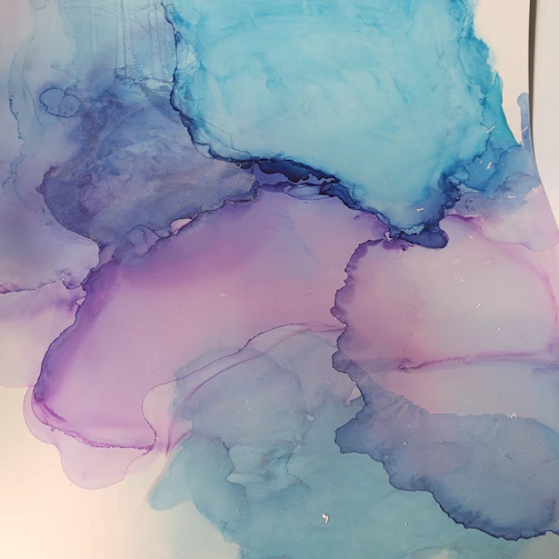 A watercolor painting blending soft blues and reds, symbolizing the connection between healing and artistic expression.