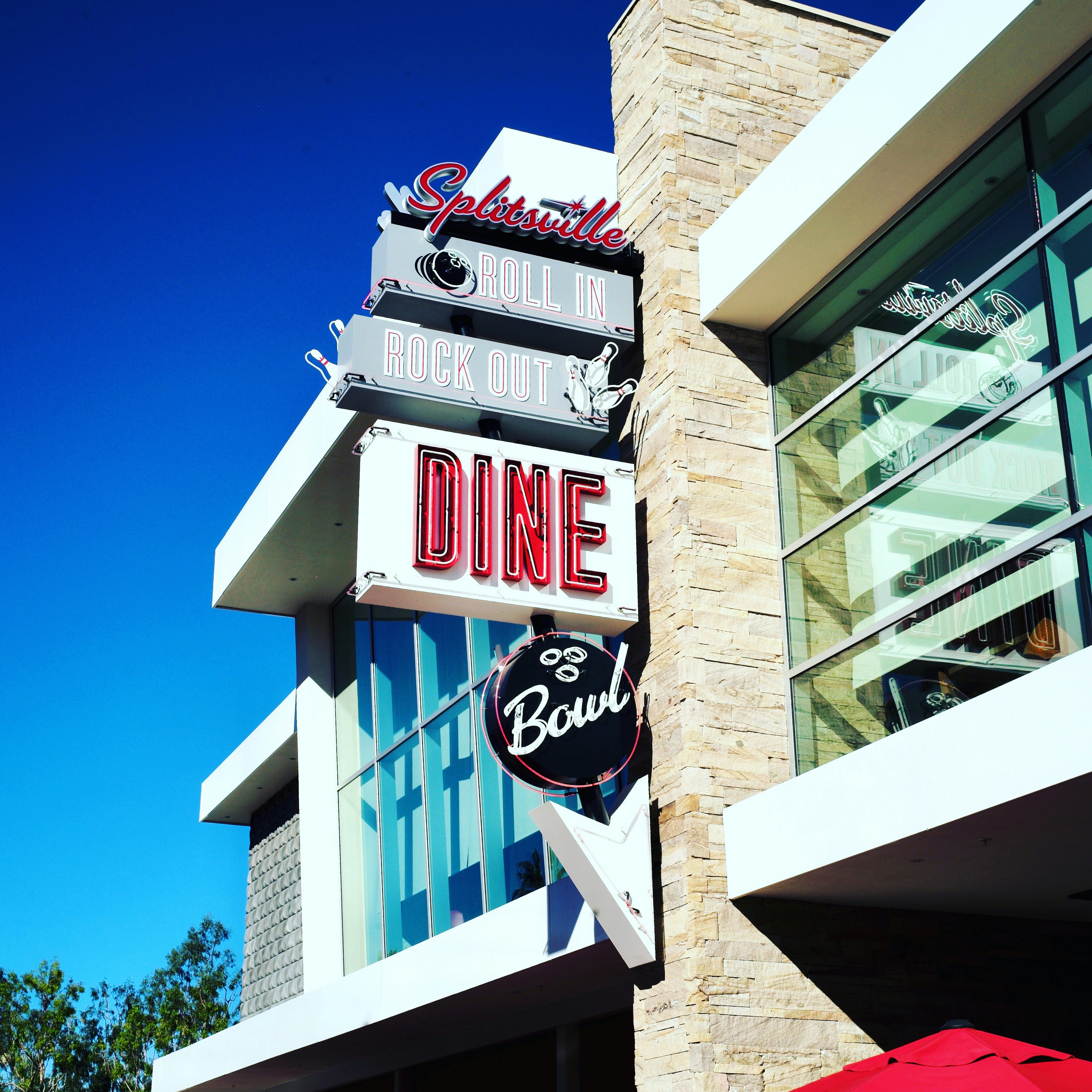 A restaurant sign on the side of a building photo – Free City Image on ...