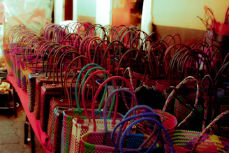 Handwoven colorful Amazonian baskets displayed on a rustic wooden table.