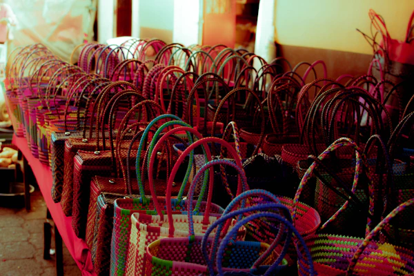 Handwoven colorful Amazonian baskets displayed on a rustic wooden table.
