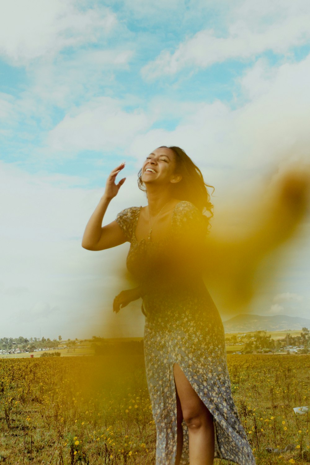 a woman in a dress standing in a field