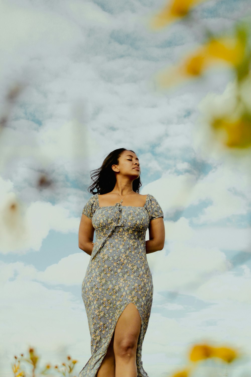 a woman standing in a field of sunflowers