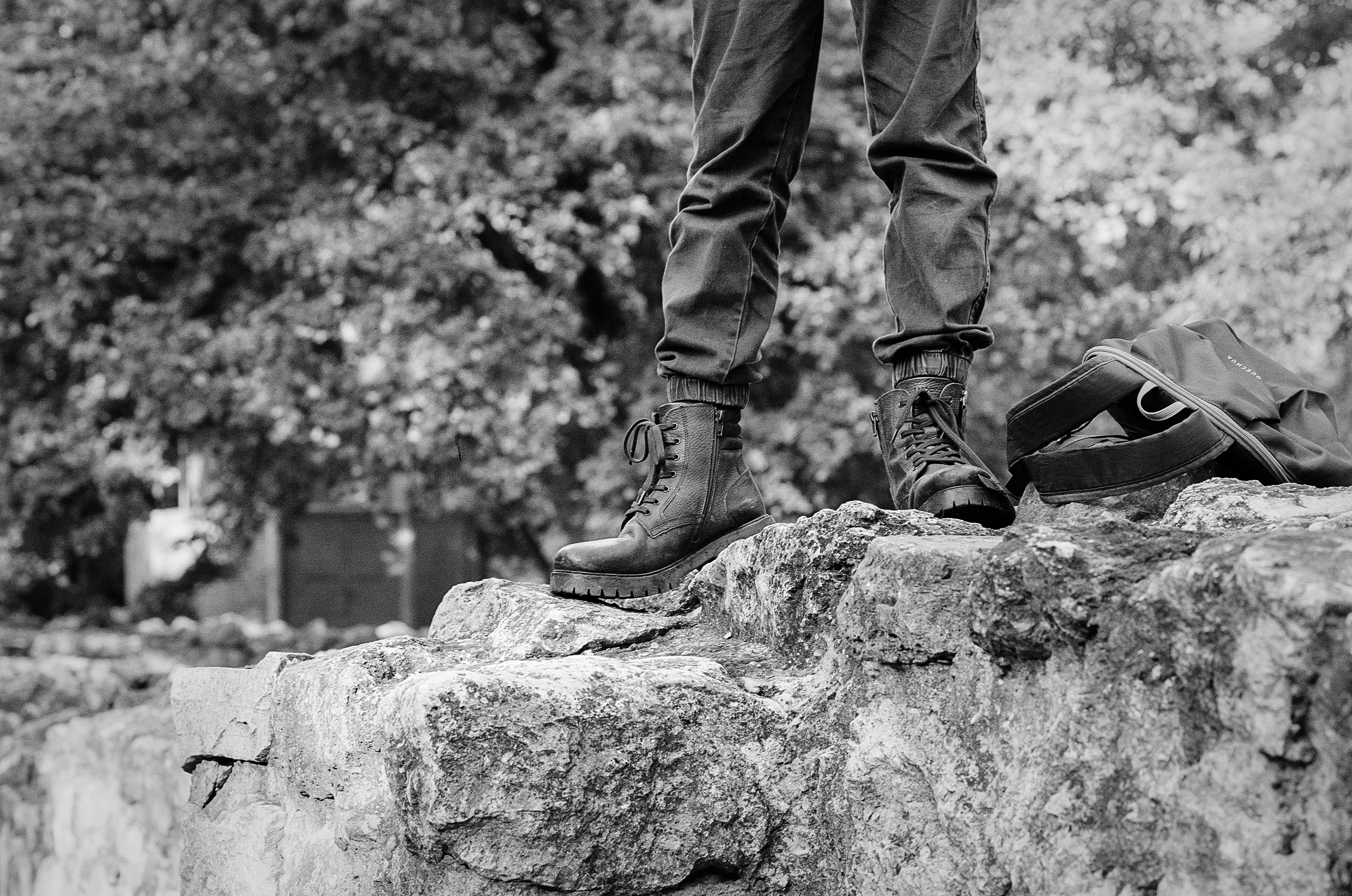 a person standing on top of a large rock
