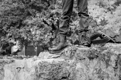 a person standing on top of a large rock