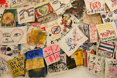 Artistic textiles and scarves featuring Ecuadorian illustrator collaborations.