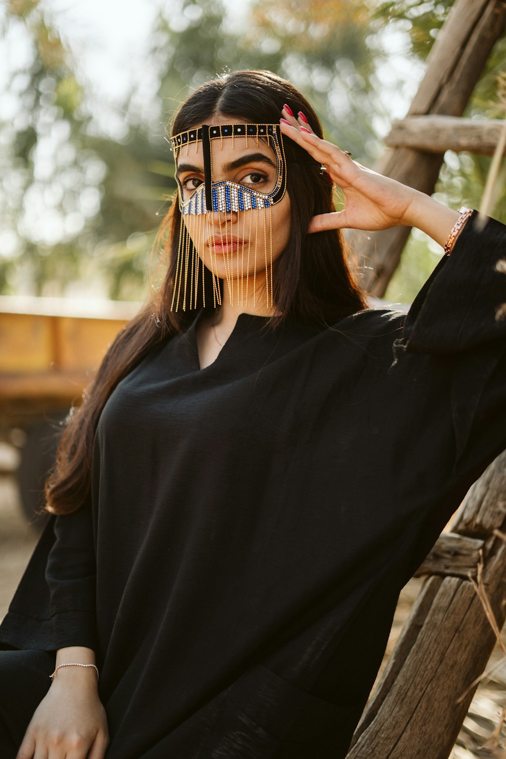 a woman in a black shirt with a mask on her face