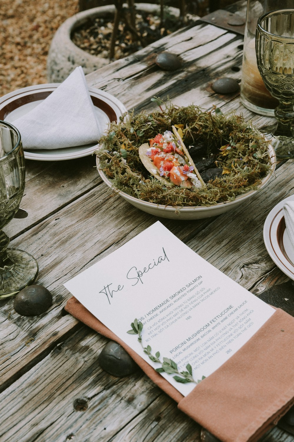 a wooden table topped with plates of food