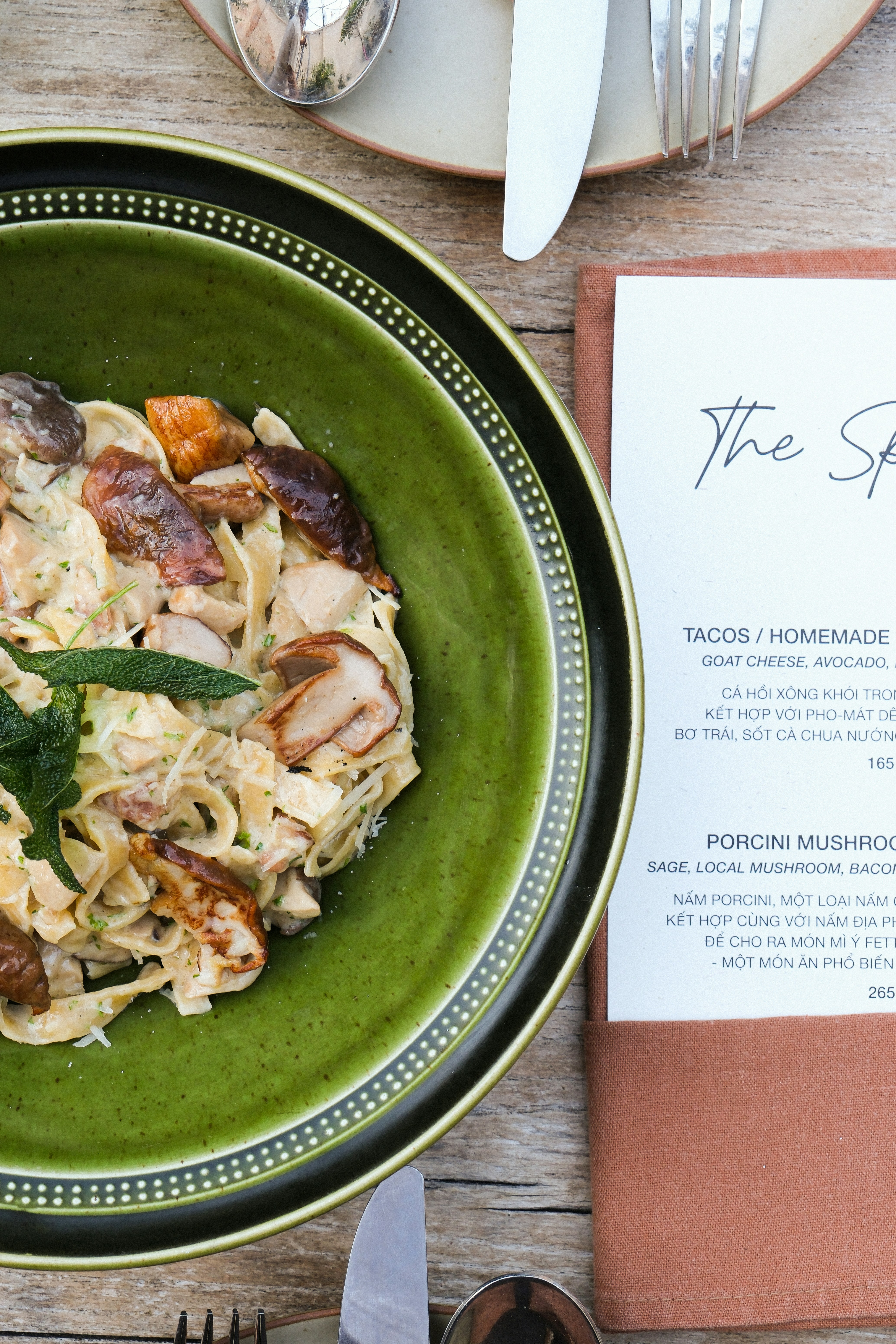 木製のテーブルの上に食べ物が入った緑色のボウル