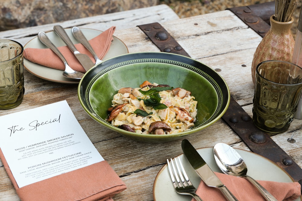 a bowl of food sitting on top of a wooden table