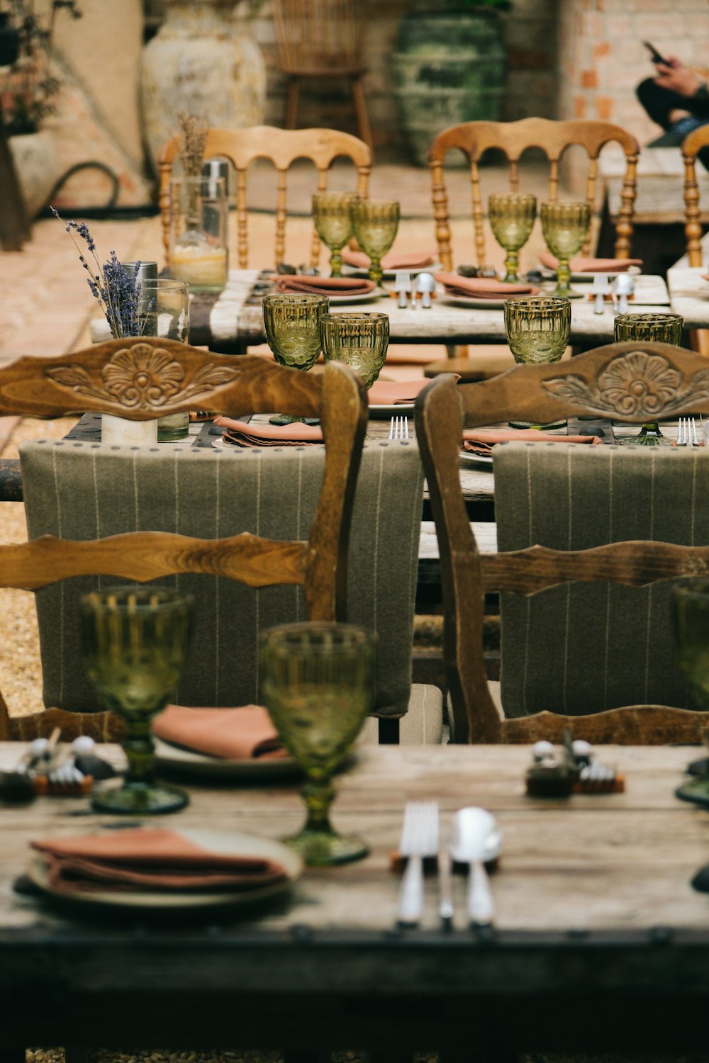 a wooden table topped with lots of chairs