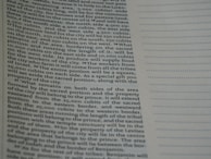 A close-up view of a page from a book containing printed text. The text is structured in paragraphs and discusses measurements, locations, and property designations. On the right side, there is a column with evenly spaced, horizontal, dotted lines.