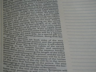 A close-up view of a page from a book containing printed text. The text is structured in paragraphs and discusses measurements, locations, and property designations. On the right side, there is a column with evenly spaced, horizontal, dotted lines.