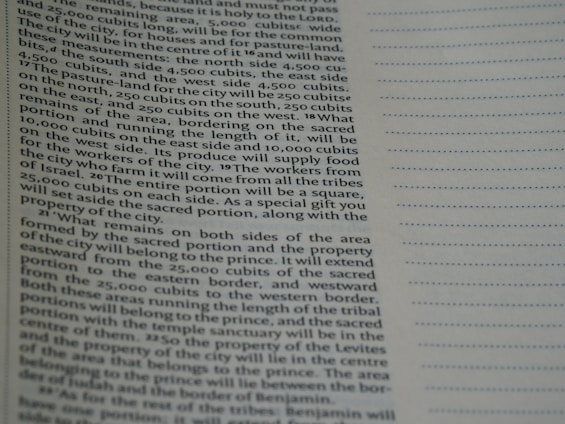 A close-up view of a page from a book containing printed text. The text is structured in paragraphs and discusses measurements, locations, and property designations. On the right side, there is a column with evenly spaced, horizontal, dotted lines.