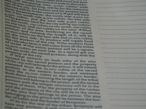 A close-up view of a page from a book containing printed text. The text is structured in paragraphs and discusses measurements, locations, and property designations. On the right side, there is a column with evenly spaced, horizontal, dotted lines.
