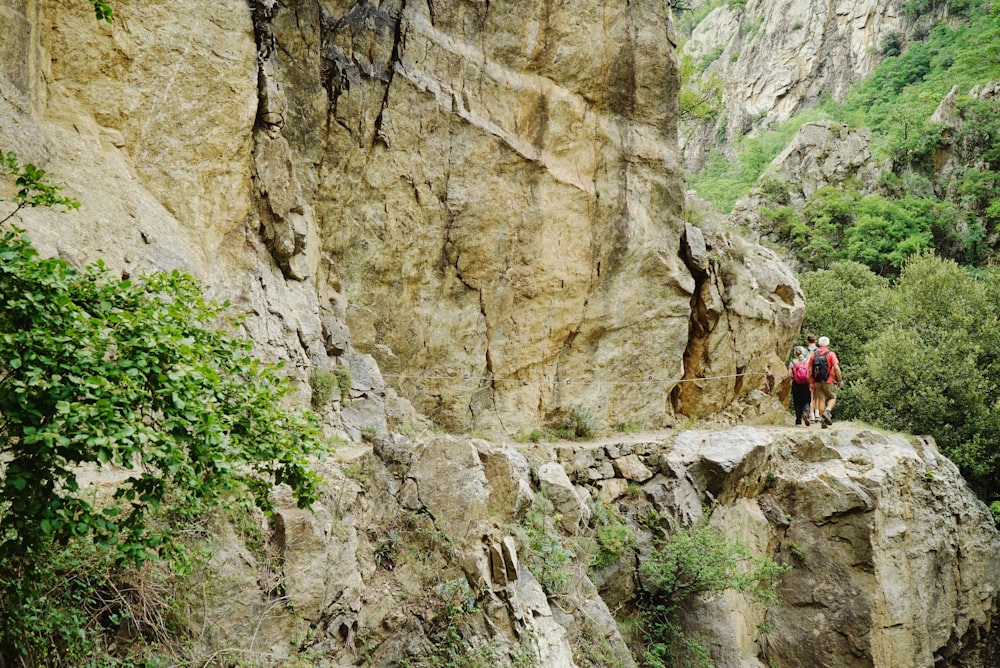 a couple of people that are standing on some rocks