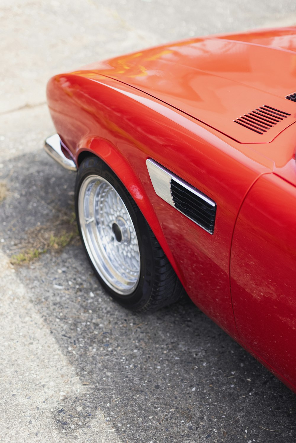 a red sports car parked on the side of the road