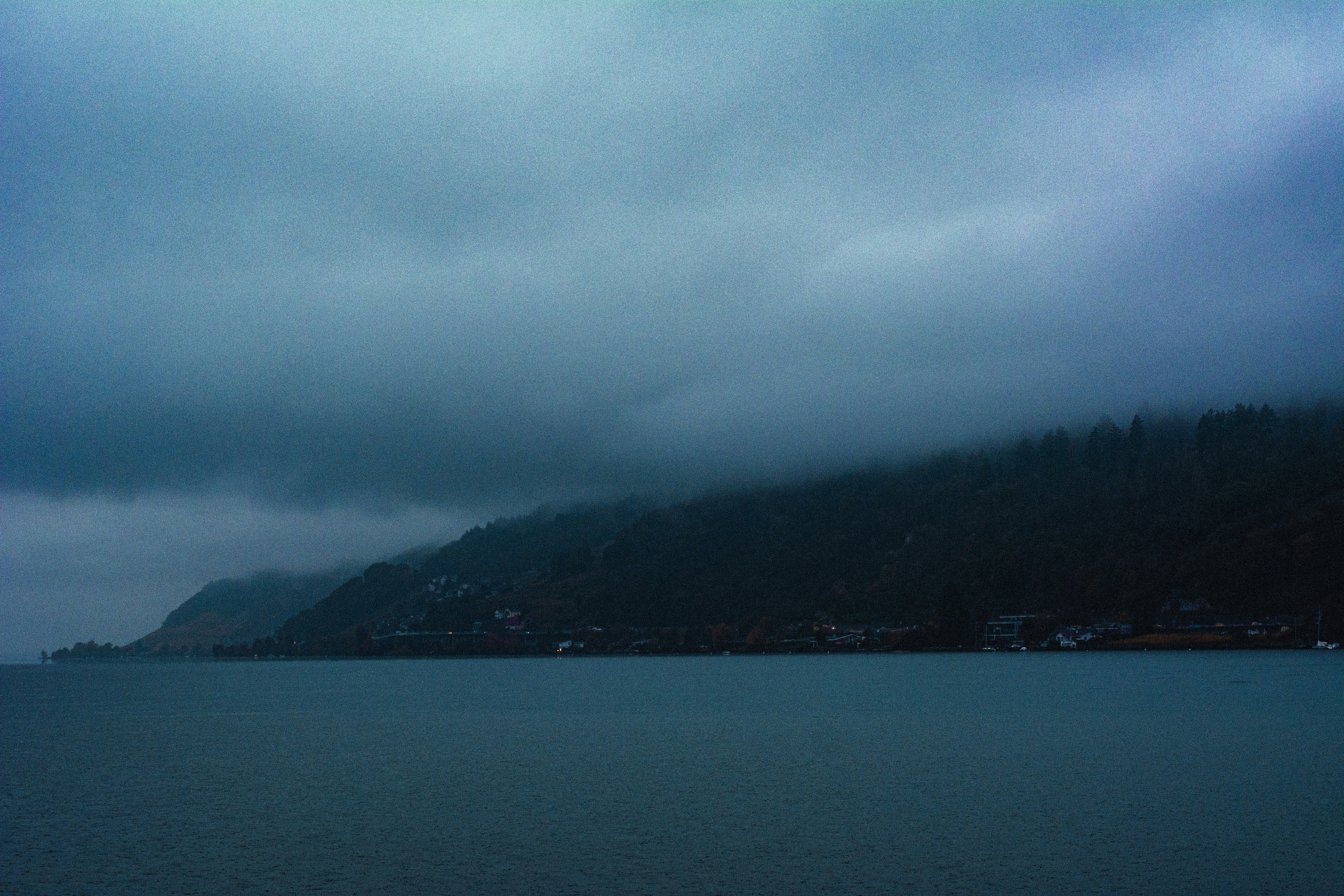 a large body of water under a cloudy sky