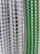 A neatly stacked assortment of colorful school notebooks and paper products.