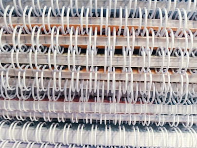 Stacks of elegantly bound books and magazines showcasing perfect and spiral bindings.