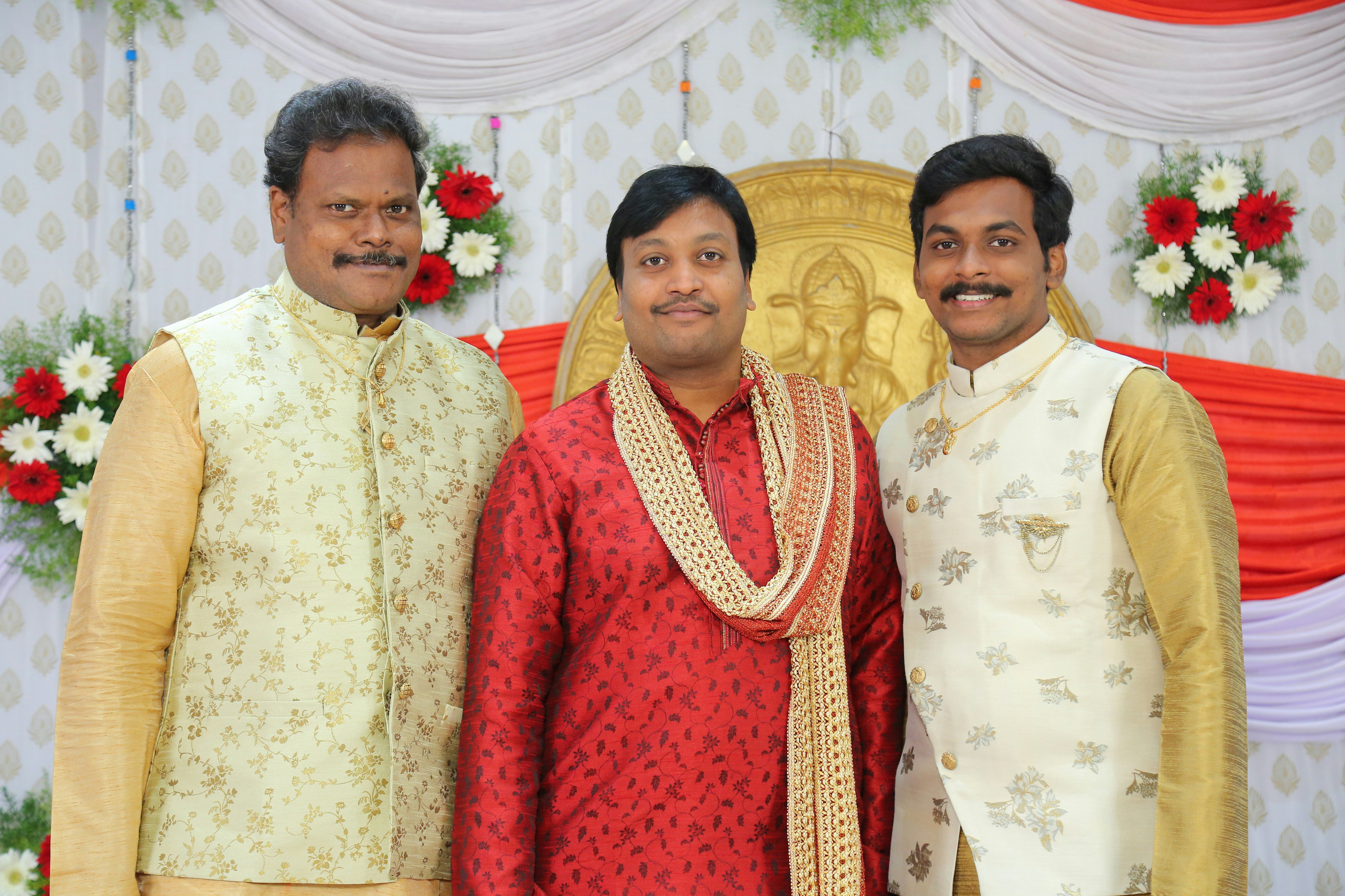 a group of three men standing next to each other