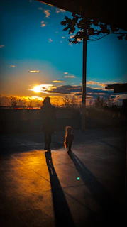 A happy dog enjoying a quiet walk with its owner during a calm sunset