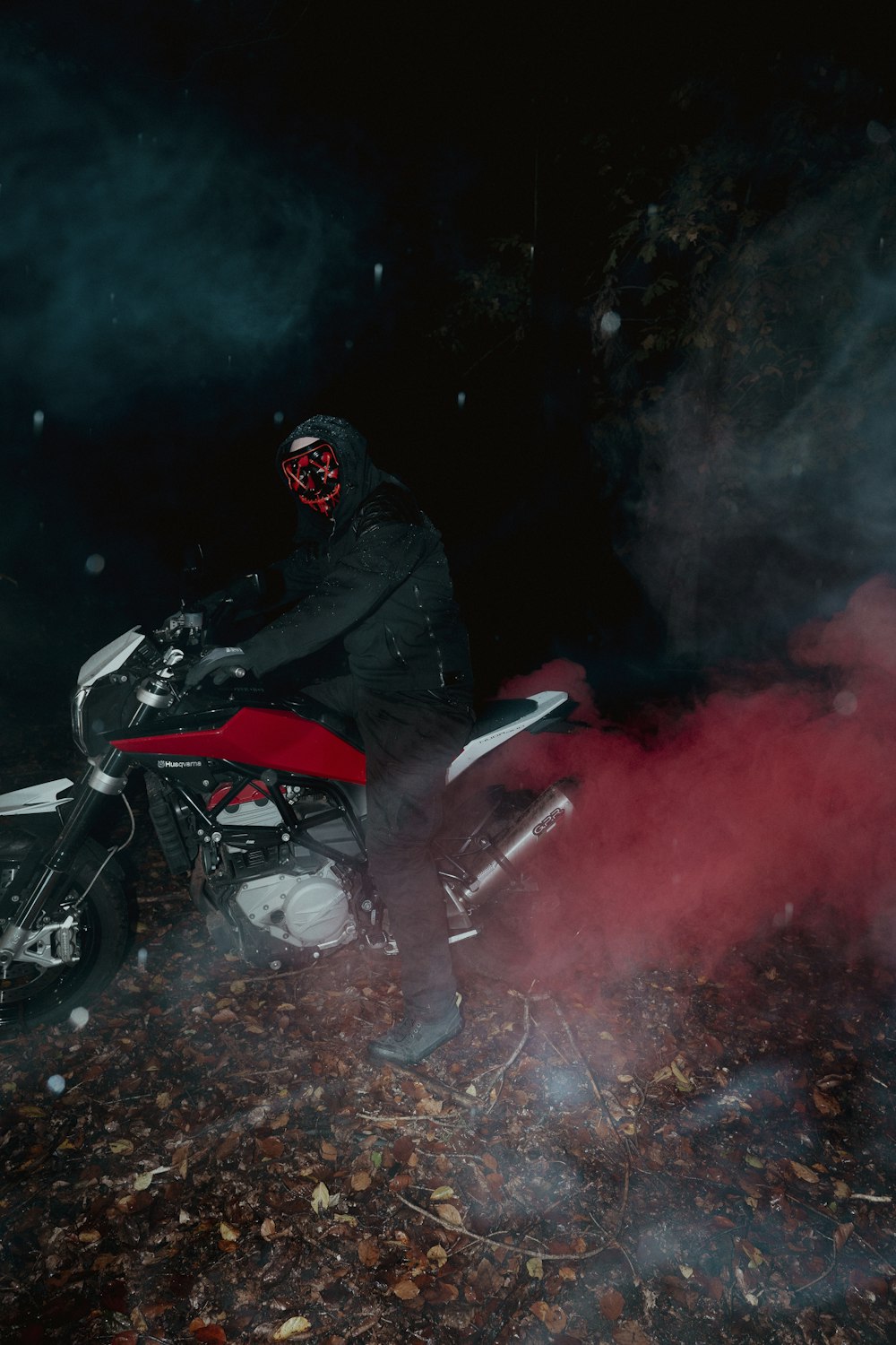 a person on a motorcycle in the dark