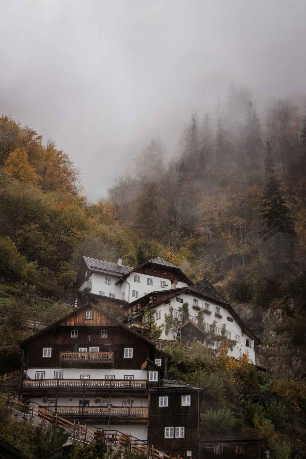 a group of buildings on a hill with trees in the background