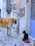 A large tan dog and a black cat are interacting in an alleyway. The street is paved with cobblestones and scattered with pink flower petals. The dog is looking down at the cat, which is sitting beside a container of food. The building wall behind them is a mix of stone and plaster.