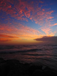 a sunset over a body of water with waves