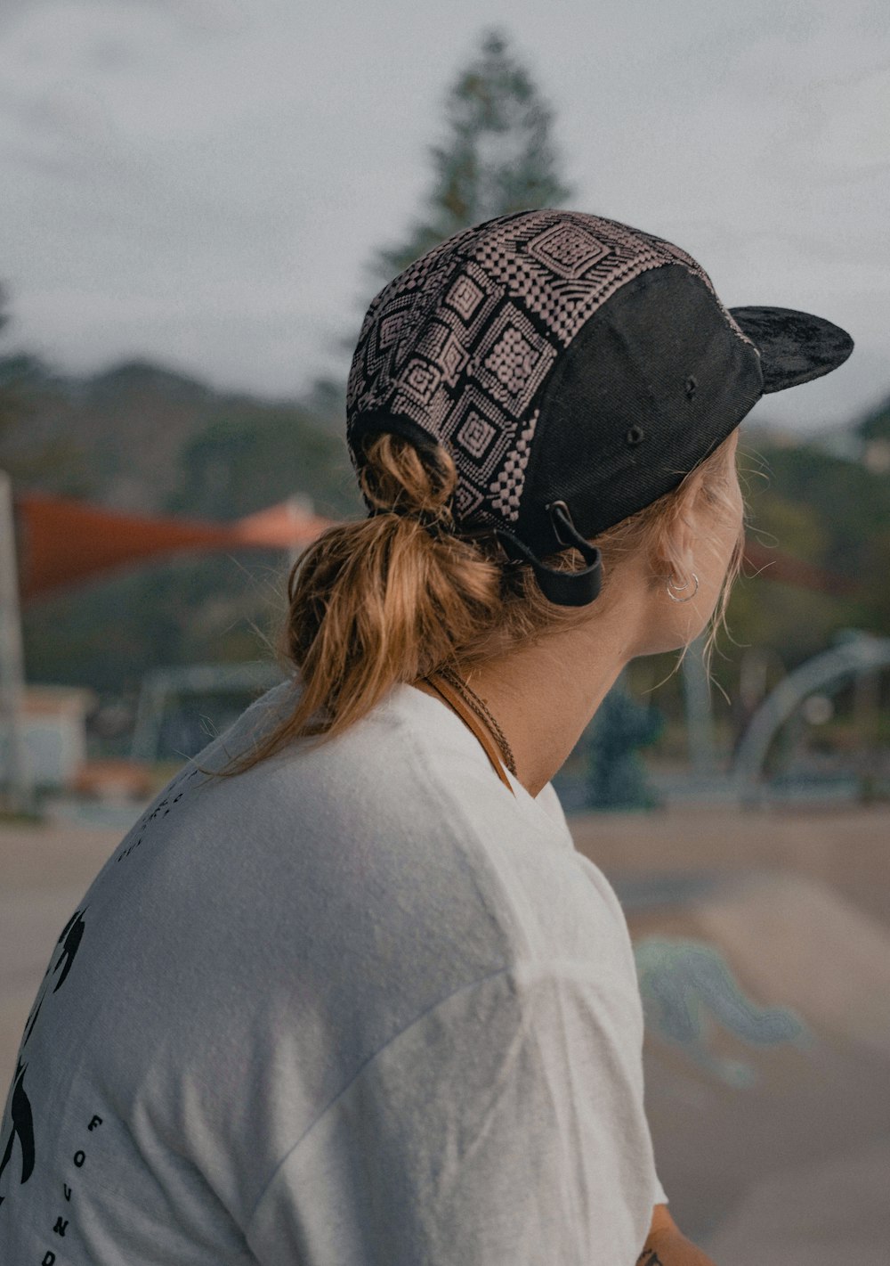 a woman with a ponytail wearing a hat