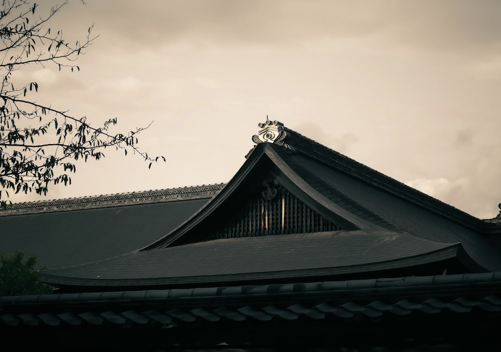 the roof of a building with a tree in front of it