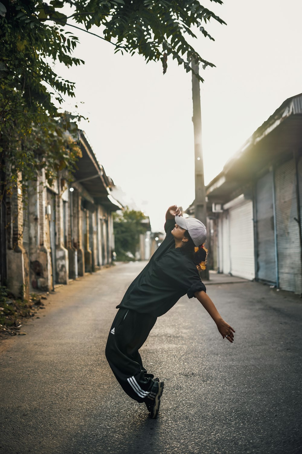 a young man riding a skateboard down a street