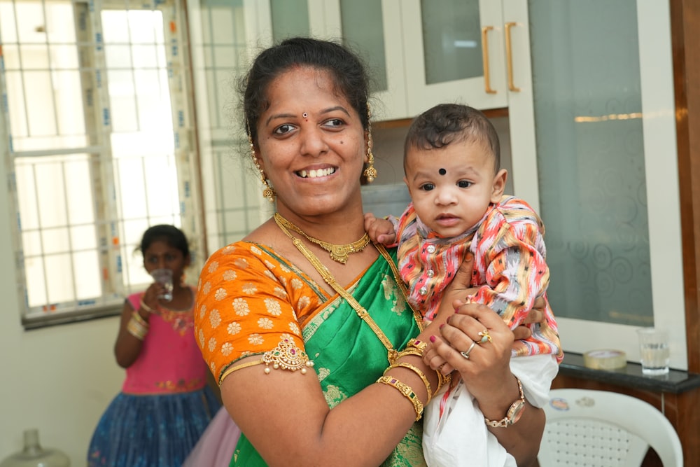 a woman holding a baby in her arms