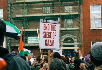 a group of people holding signs and flags