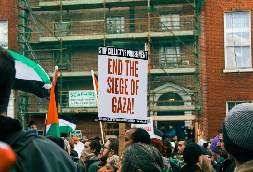 a group of people holding signs and flags