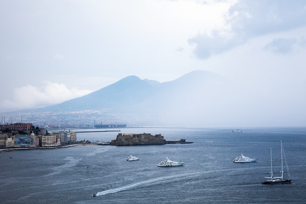 a group of boats floating on top of a large body of water