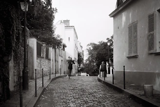 a black and white photo of a cobblestone street