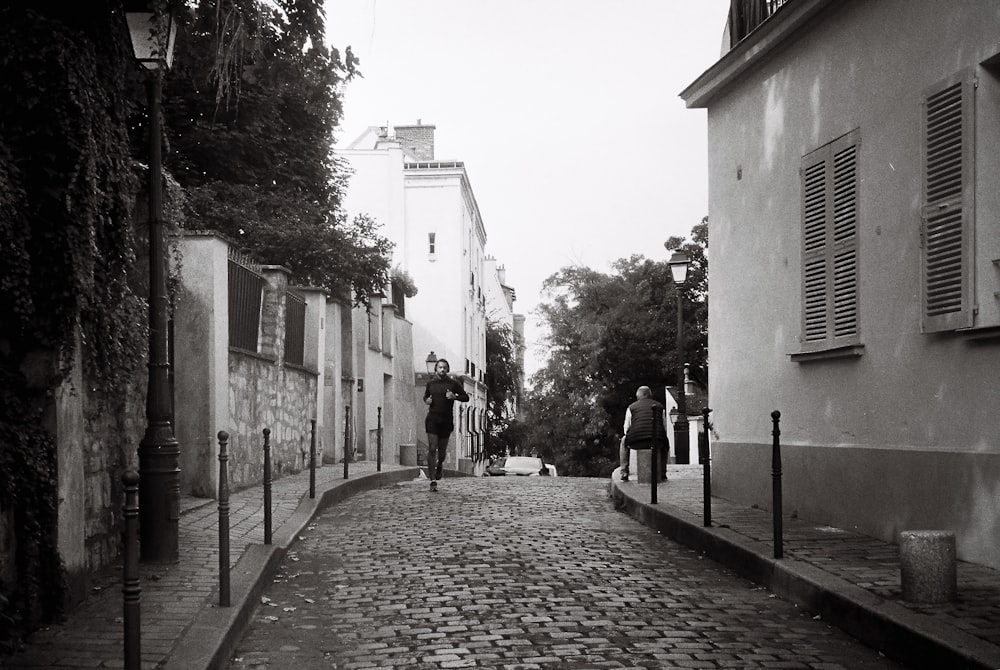 a black and white photo of a cobblestone street