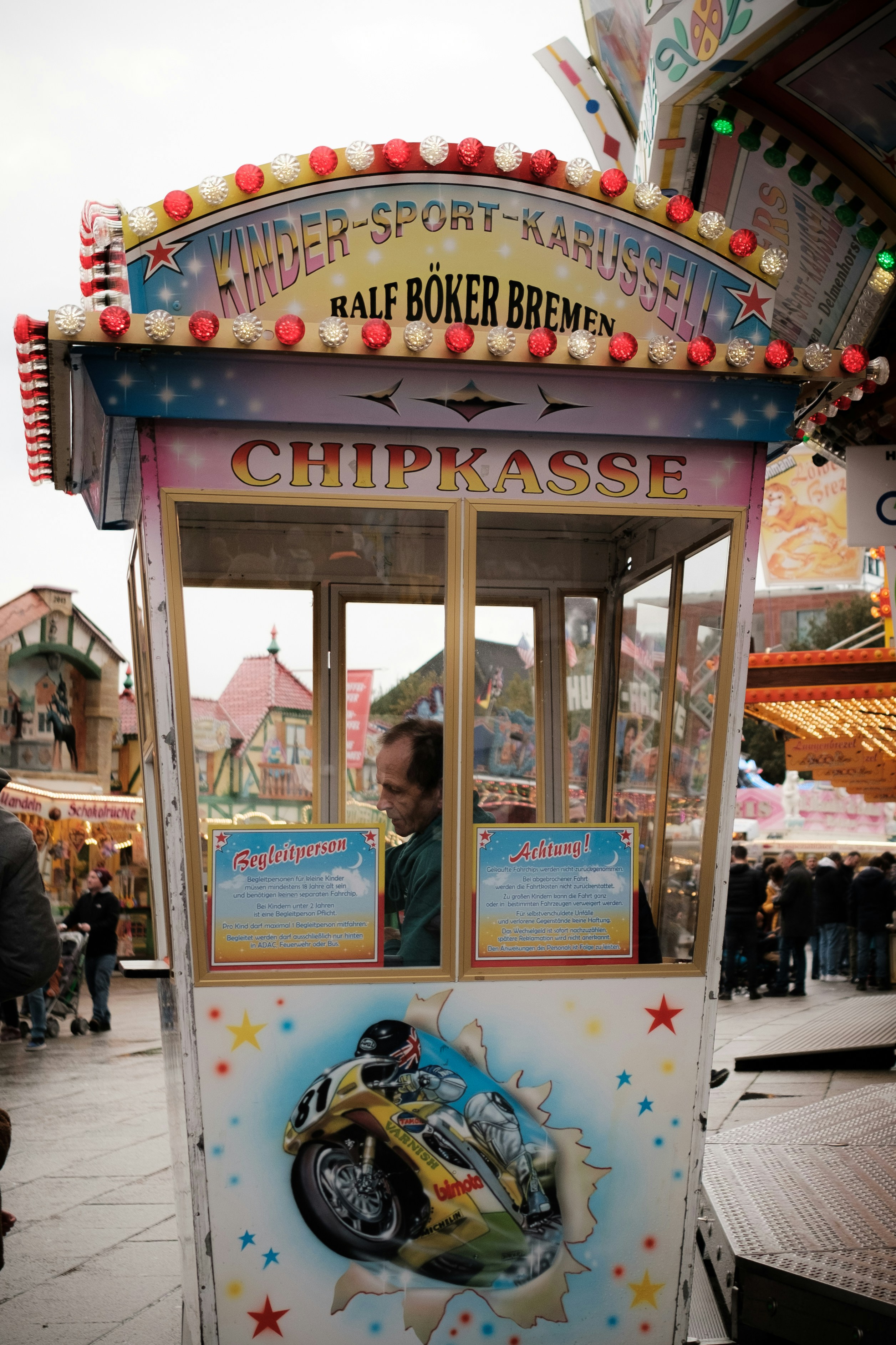 a carnival booth with a man inside of it