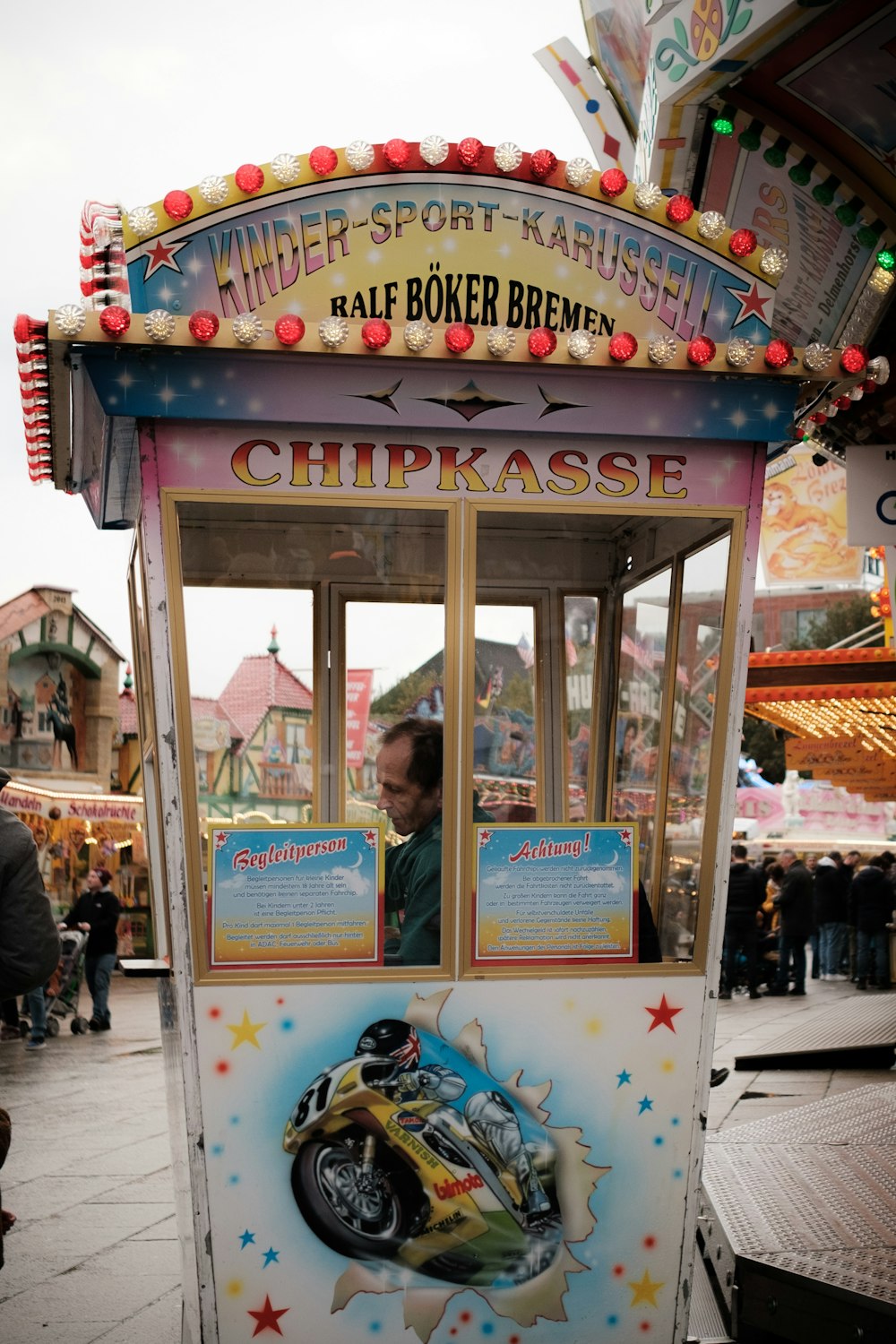 a carnival booth with a man inside of it