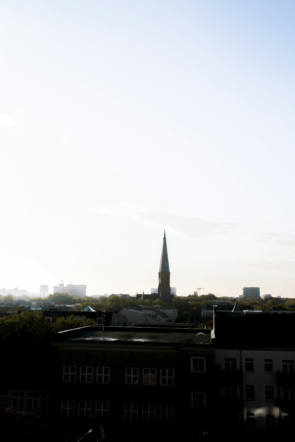 a view of a city with a church steeple in the background