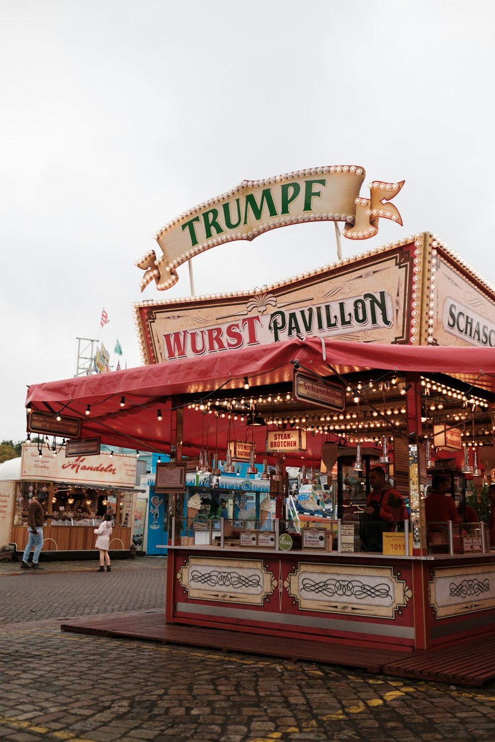 a food stand with a red canopy on top of it