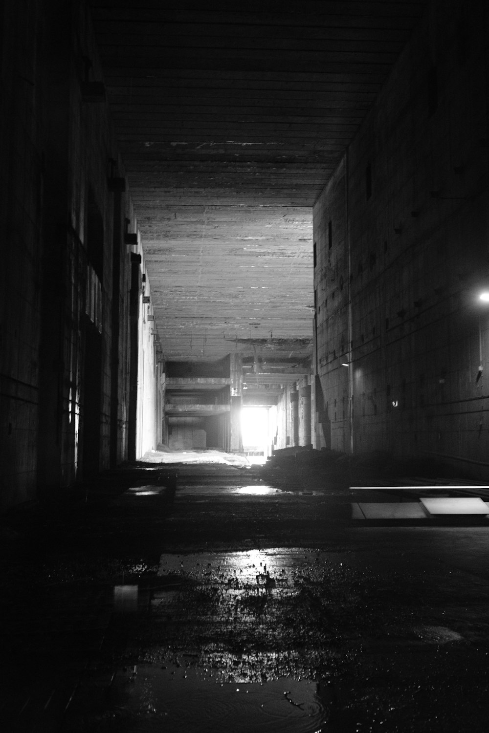 a black and white photo of a dark tunnel