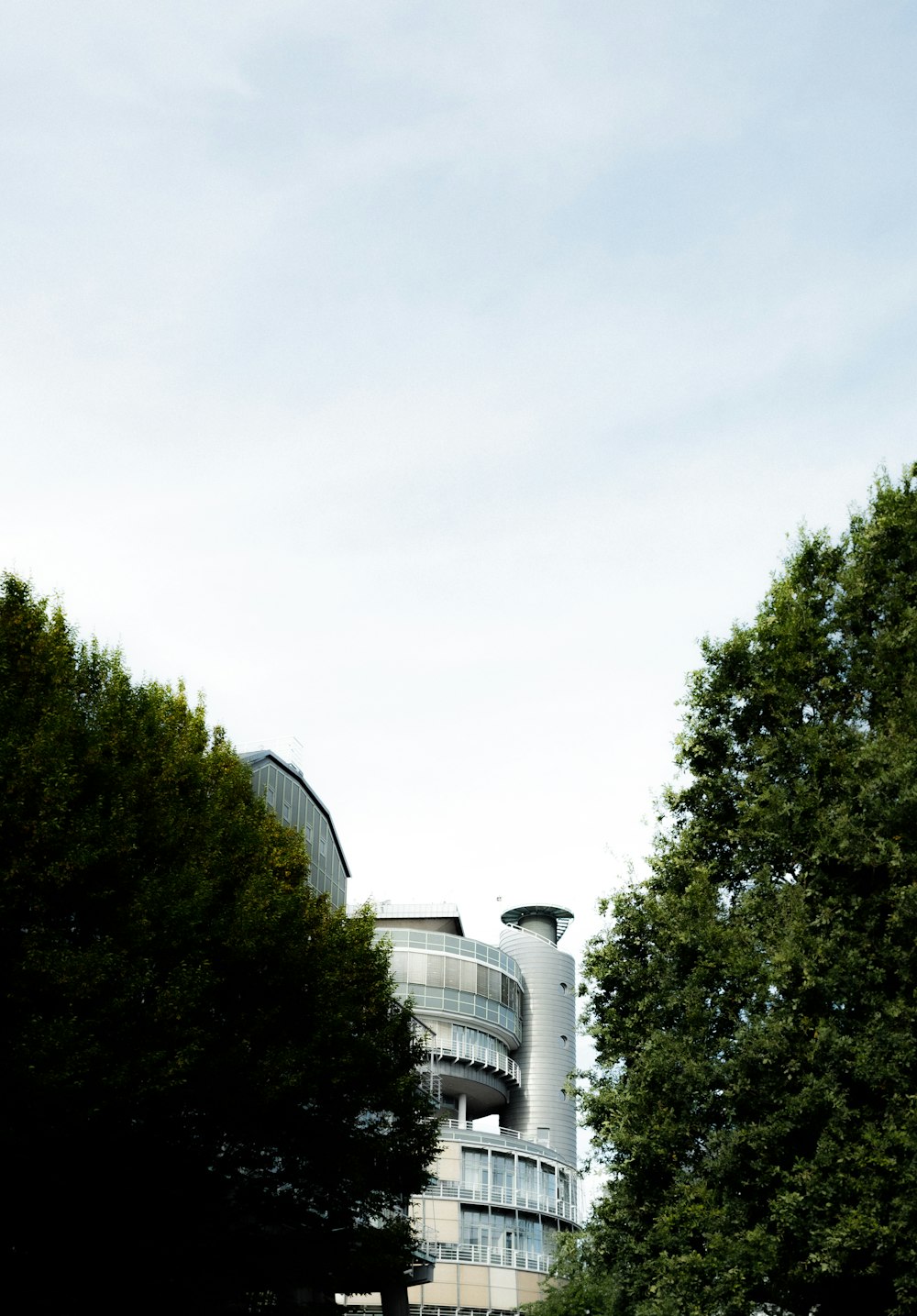 a tall building with a circular balcony on top of it