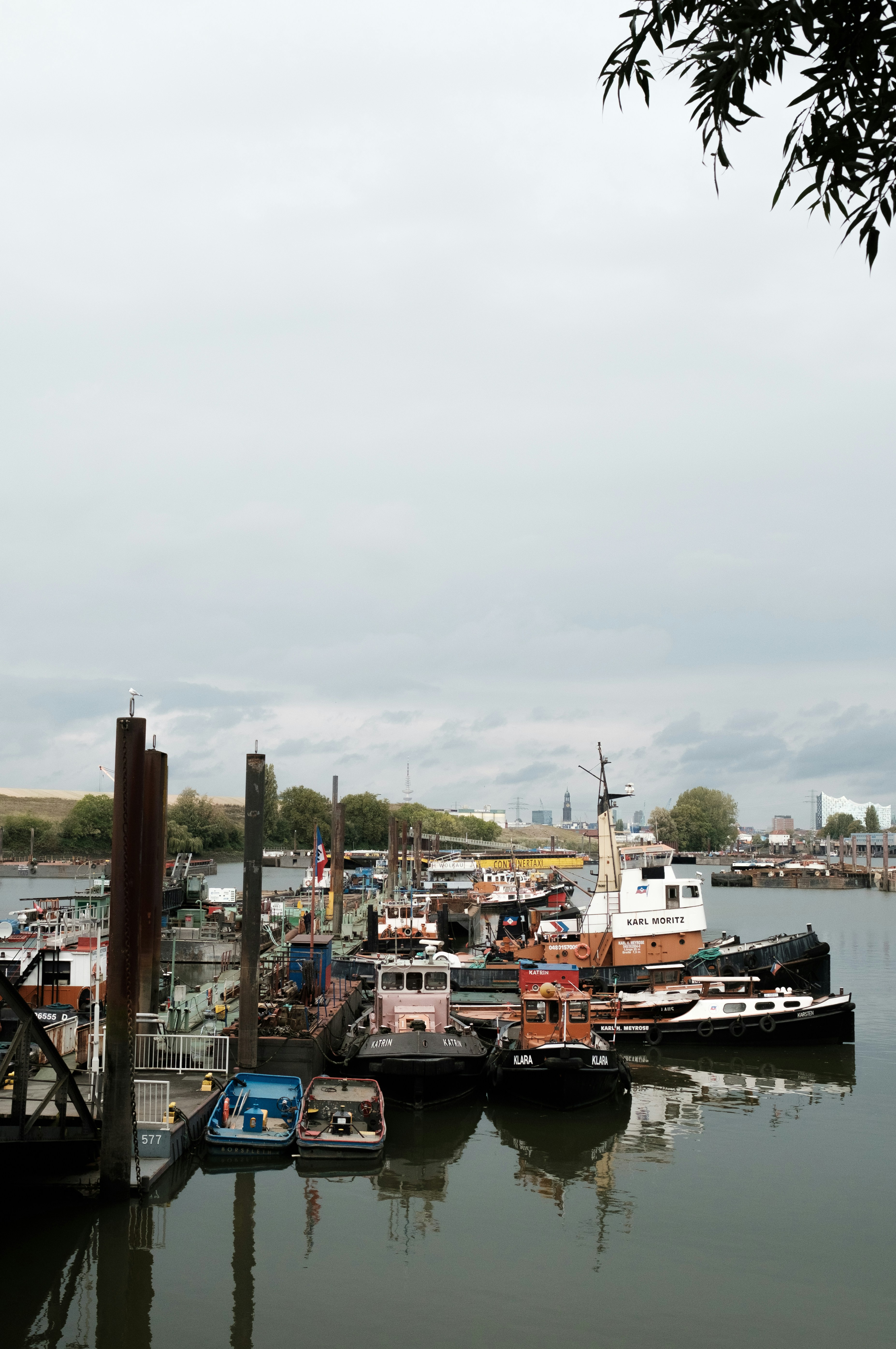 a harbor filled with lots of boats under a cloudy sky