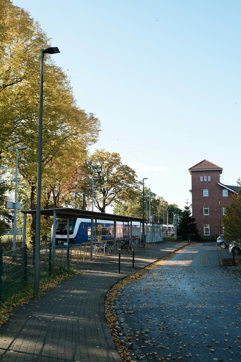 a walkway in a park with a building in the background