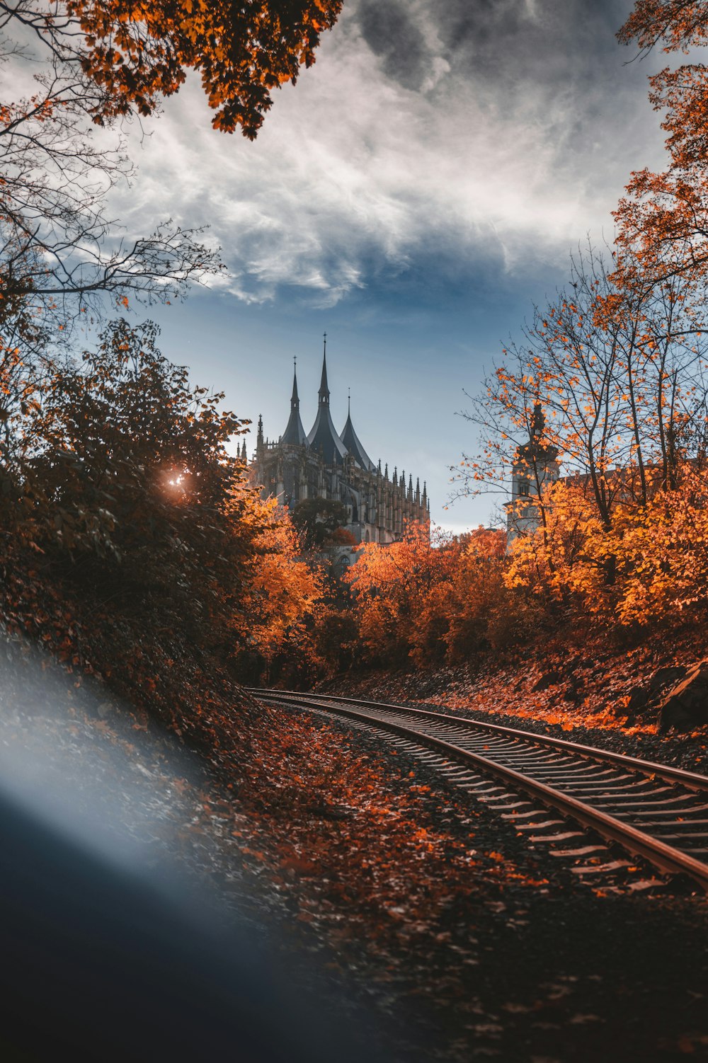 a train track with a castle in the background