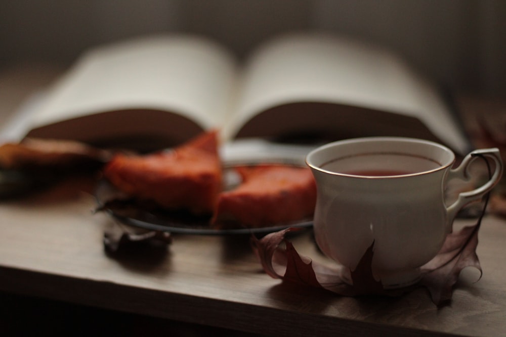 a cup of coffee and a book on a table