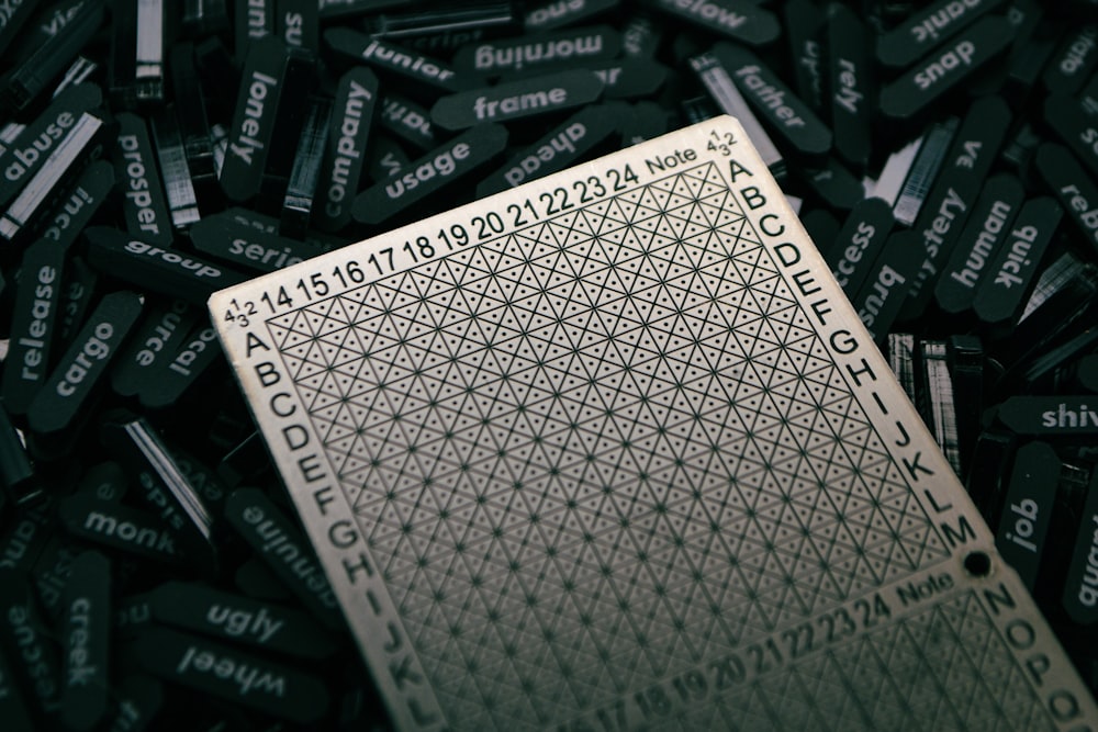 a close up of a playing card surrounded by lots of black and white letters