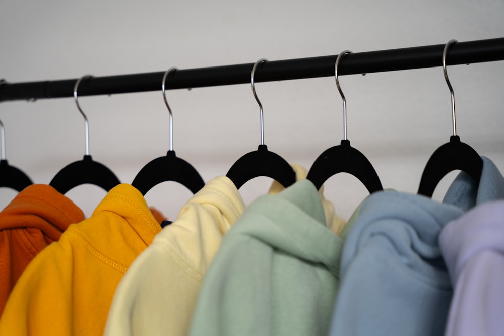 a row of shirts hanging on a rack